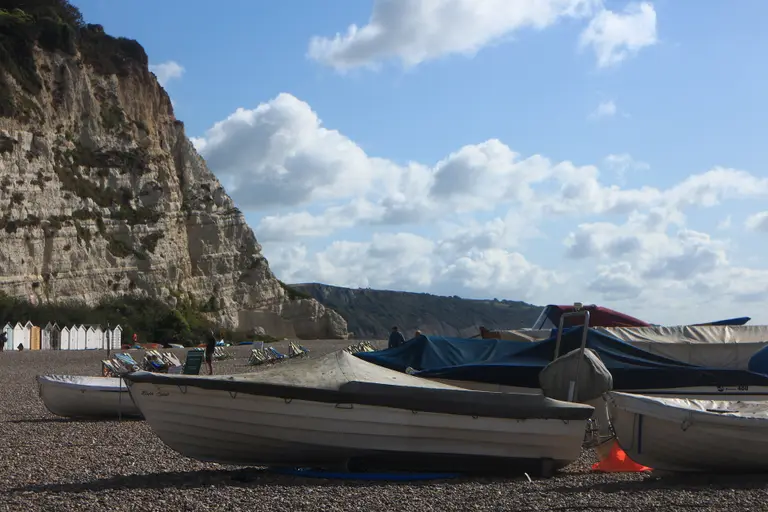 Fishing boats pulled up on the shingle beach at Beer