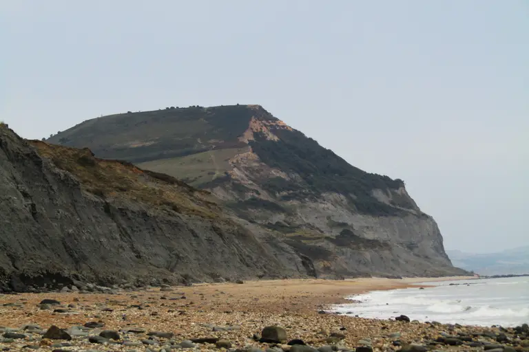 Golden Cap seen from Charmouth beach, its golden sandstone top above the dark cliffs