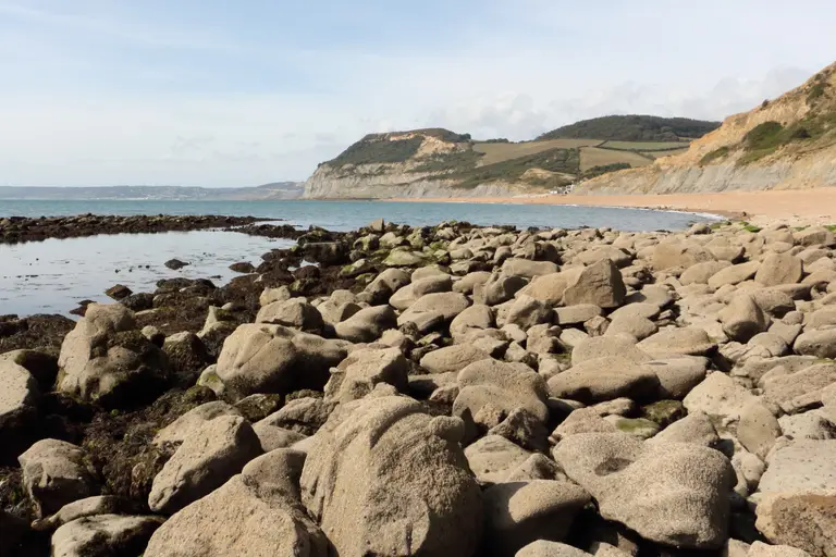 Seatown's shingle beach with Golden Cap rising behind it
